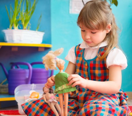 girl playing with dolls identity theft